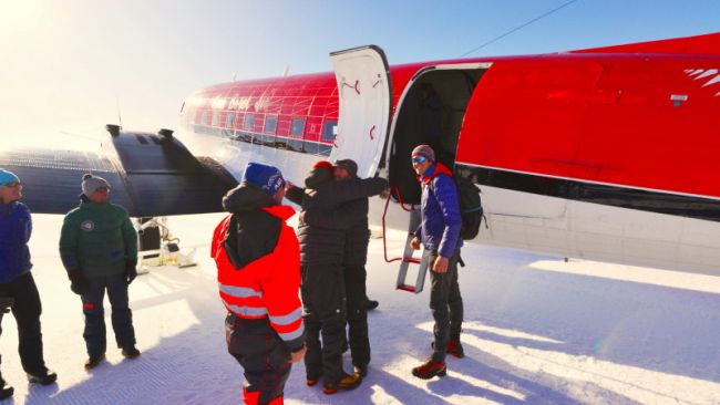 New arrival step out of a DC-3 as they arrive at the airstrip in front of PEA - © International Polar Foundation