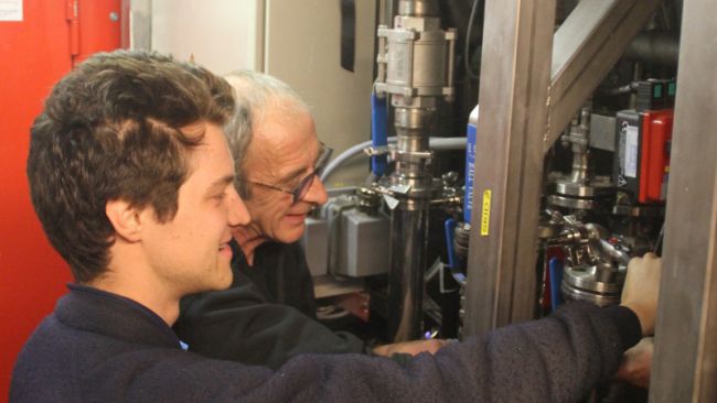 Aymar de Lichtervelde and Bernard Polet work on the PEA Station's water treatment system - © International Polar Foundation