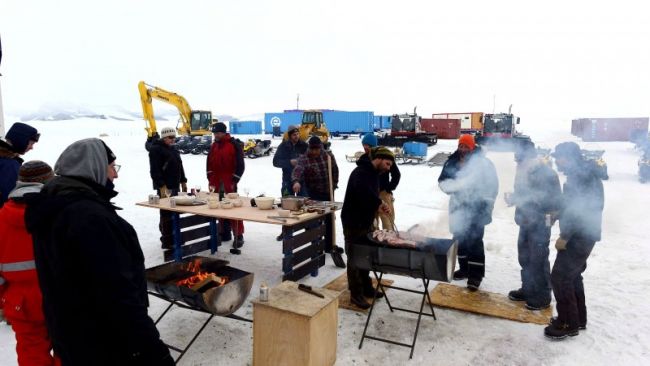 Scientists and crew at the Princess Elisabeth Antarctica enjoy a New Year's Eve barbecue - © Jos Van Hemelrijck