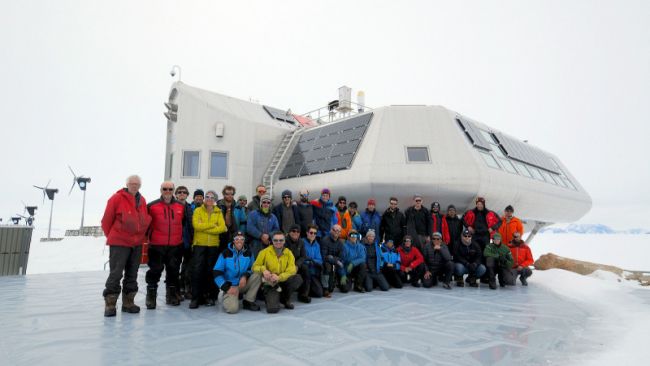 The 2019-2020 BELARE team poses for the annual group photo in front of the station - © International Polar Foundation