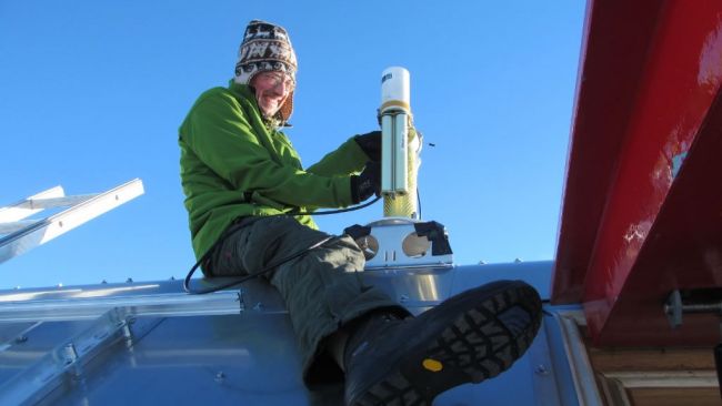 Alexander Mangold servicing his instruments on the roof - © International Polar Foundation / Alain Hubert