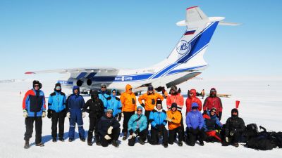 BELARE 2020-2021 team poses near Novolazarevskaya Station in front of the Ilyushin transport plane that brought them to Antarctica - © International Polar Foundation
