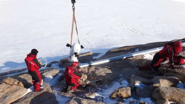 Craig, Illir and François installing the new wind turbine - © International Polar Foundation / Alain Hubert