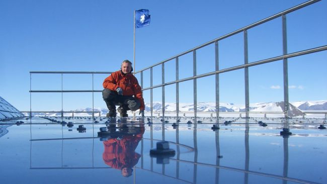 Johan Berte poses on the roof of Princess Elisabeth Antarctica - © IPF