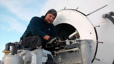 Karel at work on the satellite dish - © International Polar Foundation