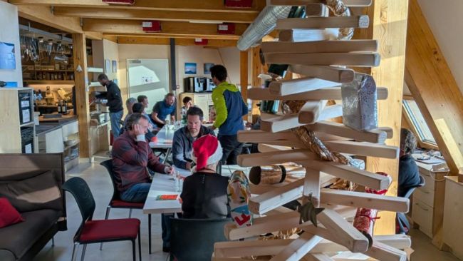 A Christmas tree crafted from leftover wood and decorated with Christmas crackers brightens the station’s living area. - &copy; International Polar Foundation