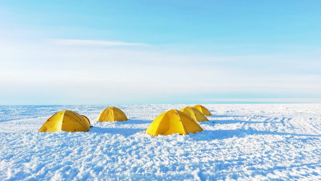 Tents from the MAss2Ant project's field camp on the Lokeryggen Ice Rise a few hours before the first massive snow storm hit in December 2021. - © International Polar Foundation / Marie Cavitte UCLouvain