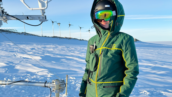 Rainette Engberg from the EPFL in Switzerland poses with a sonic anemometer used in the SnowFlux project near the 30-metre tower at PEA. - &copy; International Polar Foundation / Rainette Engberg EPFL