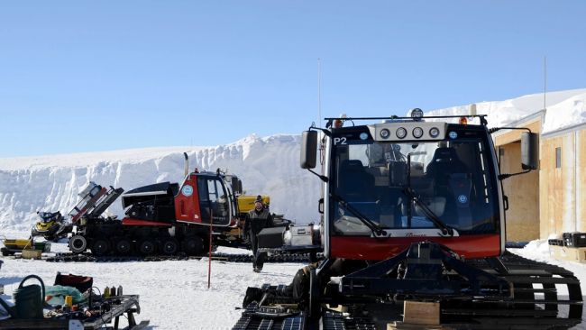 Prinoth tractors being serviced in front of the garages. - © International Polar Foundation / Jos van Hemelrijck