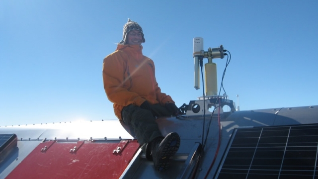 Dr. Alexander Mangold setting up an instrument on the roof of PEA - International Polar Foundation