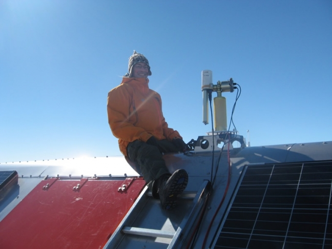 Dr. Alexander Mangold setting up an instrument on the roof of PEA - International Polar Foundation