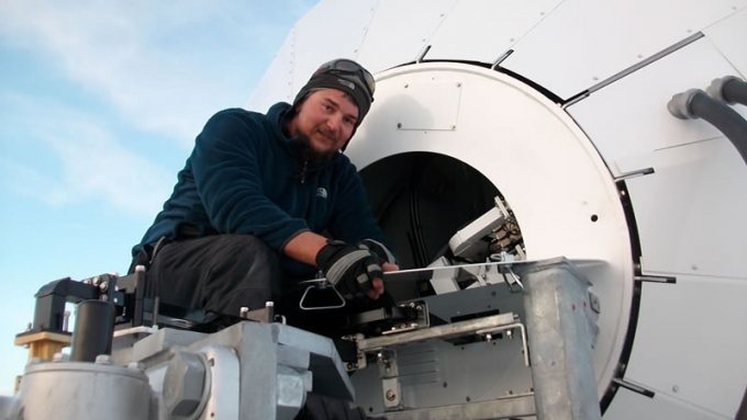 Karel at work on the satellite dish - International Polar Foundation