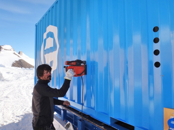 Illir working on the accommodation container. - International Polar Foundation