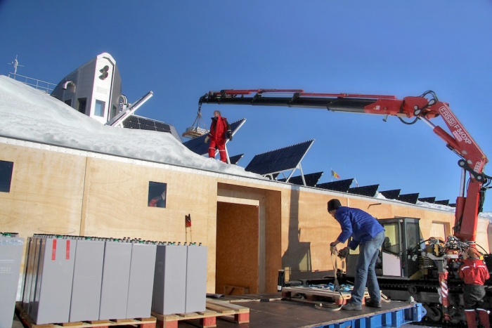 A crane is used to move the old batteries from the roof to the technical areas, where they will be packed for transport. - International Polar Foundation