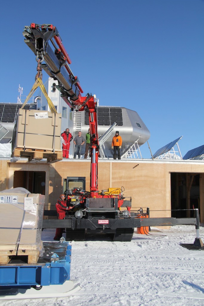 Same crane lifting the new batteries to the roof. - International Polar Foundation