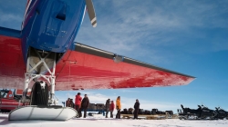 Old team members welcome the new arrivals under the wings of the Basler. - International Polar Foundation / René Robert