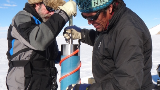 Konrad Steffen from the Swiss Federal Institute for Forest, Snow and Landscape Research (WSL) and Alain Hubert drilling to install a new weather station near the airstrip. - International Polar Foundation / Alain Hubert