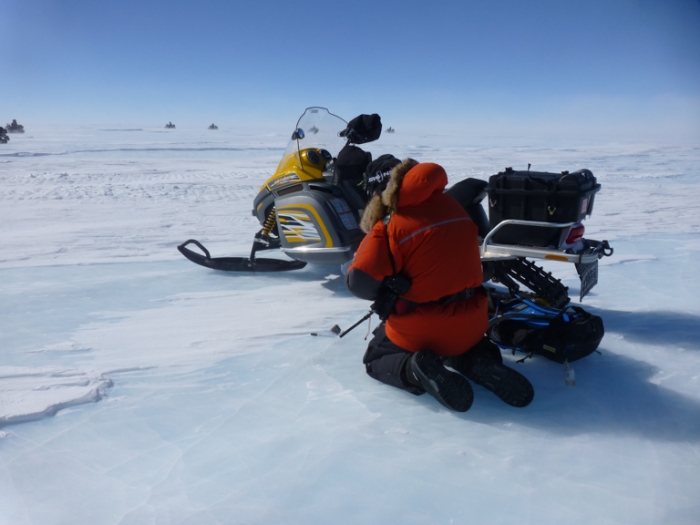 SAMBA team member finding a meteorite embedded in the Antarctic ice. - International Polar Foundation/Alain Hubert