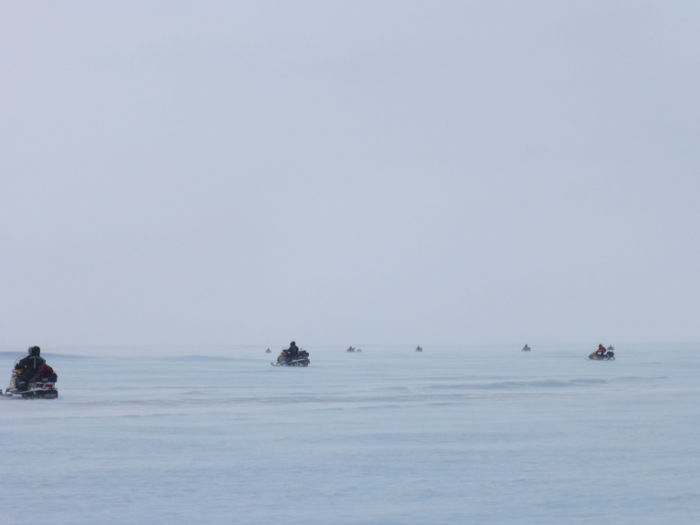 The SAMBA team take to skidoos, fanning out in a V-formation to search for meteorites. - International Polar Foundation/Alain Hubert