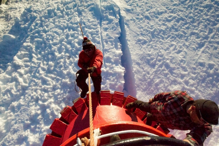 Kristof, mechanic from Princess Elisabeth Antarctica, climbs on board. - International Polar Foundation