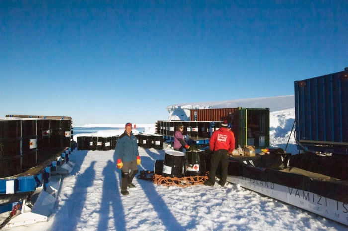 Mike Stroud supervising the transfer of 100,000 litres of fuel into the bladders on the sledges. - International Polar Foundation