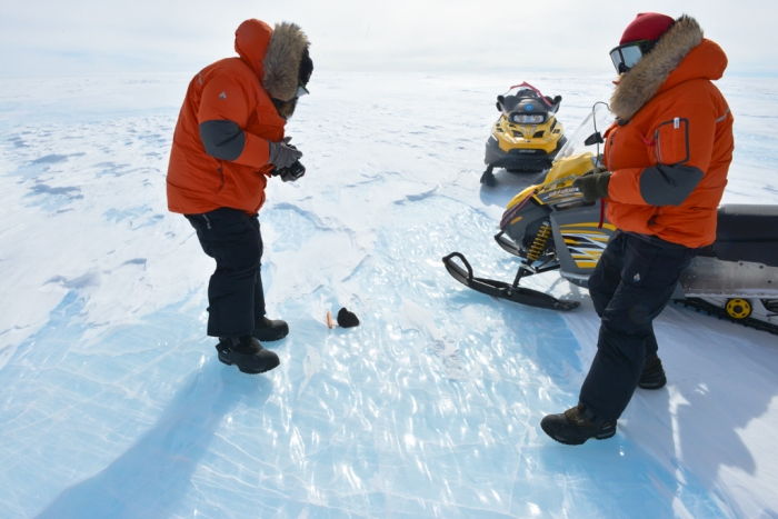 Belgo-Japanese SAMBA meteorite team members photographing a meteorite found during a field trip on the Nansen Ice Field, 140km south of Princess Elisabeth Antarctica, during the BELARE 2012-2013 expedition.  - International Polar Foundation