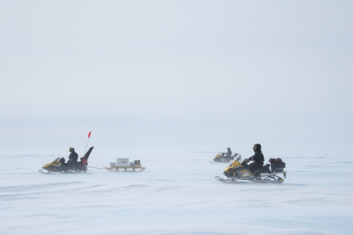 Members of the Belgo-Japanese SAMBA team, mounted on skidoos, fan out in v-shaped formation across the Nansen Ice Field, in order to search for meteorites during a field trip on the plateau, 140km south of Princess Elisabeth Antarctica. - International Polar Foundation