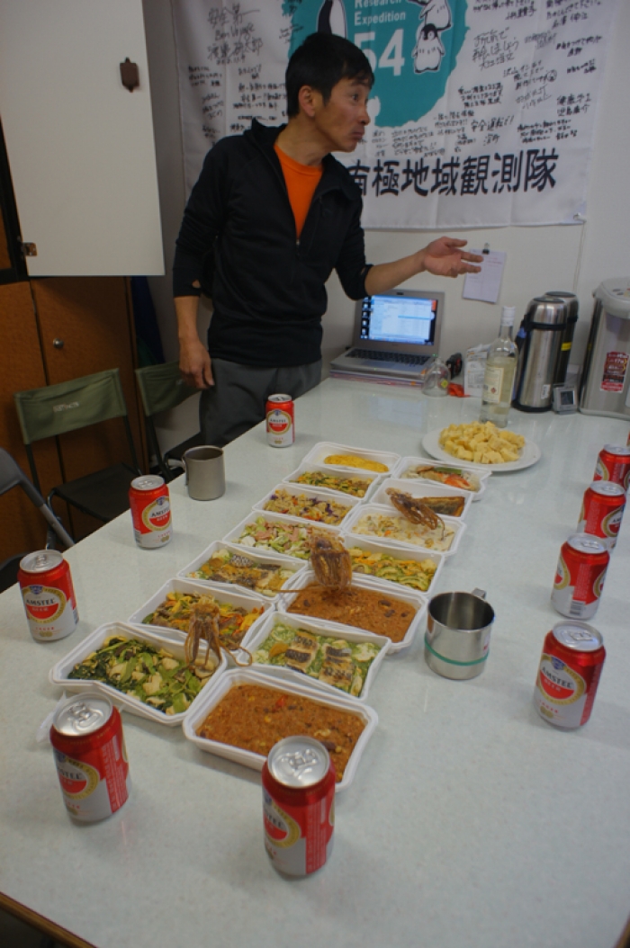 Belgo-Japanese SAMBA meteorite team member setting the dining table with Japanese food in the living container at the basecamp situated on the plateau, during a field trip on the Nansen Ice Field, 140km south of Princess Elisabeth Antarctica, during the BELARE 2012-2013 expedition.  - International Polar Foundation