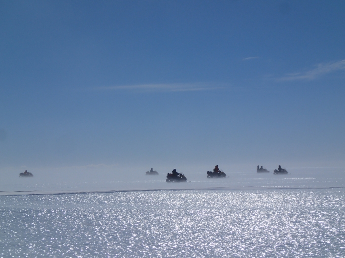 Members of the Belgo-Japanese SAMBA team, mounted on skidoos, fan out in v-shaped formation across the Nansen Ice Field, in order to search for meteorites during a field trip on the plateau, 140km south of Princess Elisabeth Antarctica. - International Polar Foundation