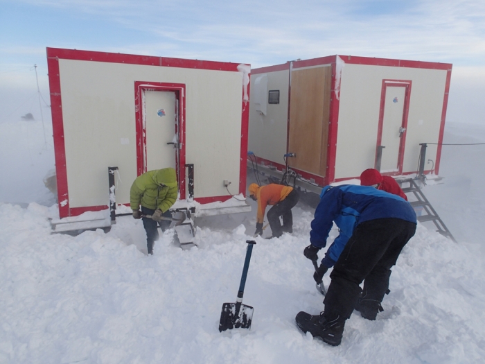 Belgo-Japanese SAMBA meteorite team digging clearing basecamp of the snow, during a field trip on the Nansen Ice Field, 140km south of Princess Elisabeth Antarctica, during the BELARE 2012-2013 expedition.  - International Polar Foundation