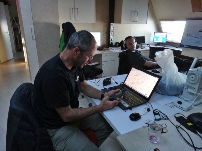 Benoît is planning the route for one of our daily reconnaissance trips with the geologists and the pilots.
 - International Polar Foundation
