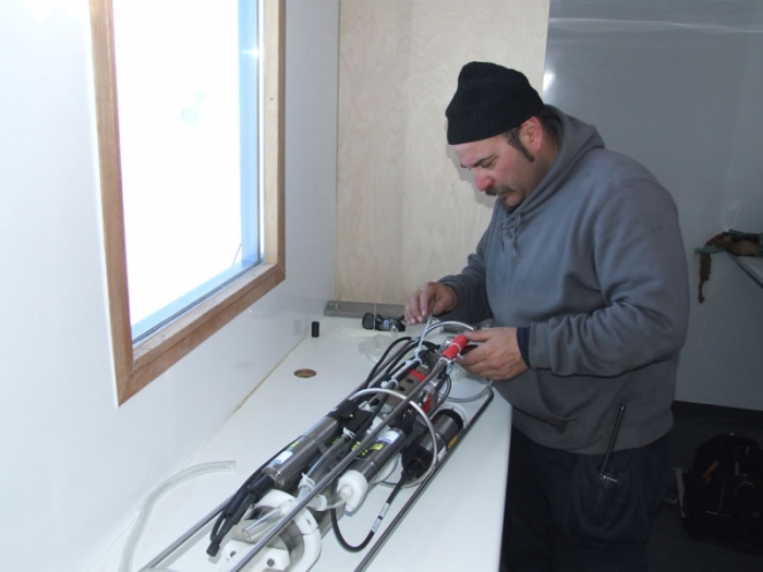 Kristof Soette, our chief mechanic prepares the CTD (Conductivity, Temperature, Depth) equipment for us in a glaciology field expedition this year. - International Polar Foundation