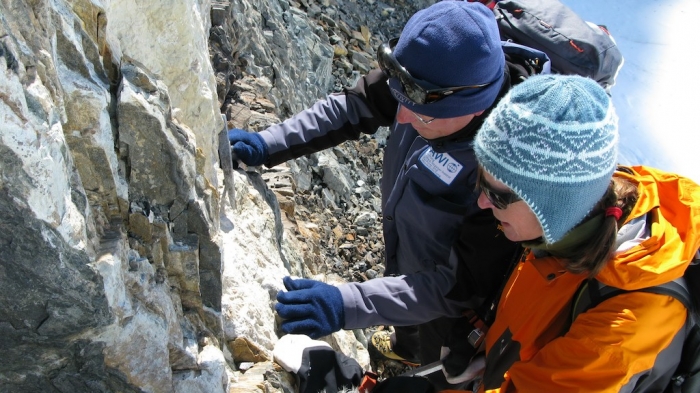 Joachim (AWI) discussing characteristics of rocks on-site site. - International Polar Foundation