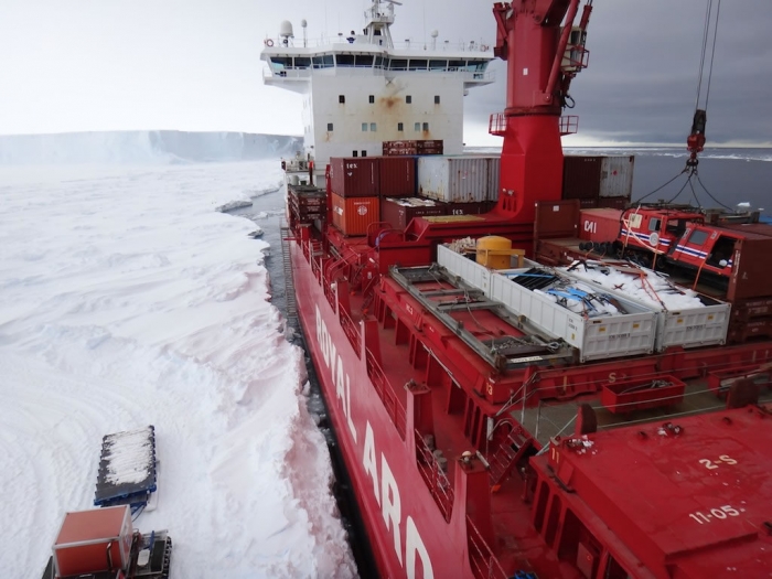 The ship's crane lifting a container. - International Polar Foundation