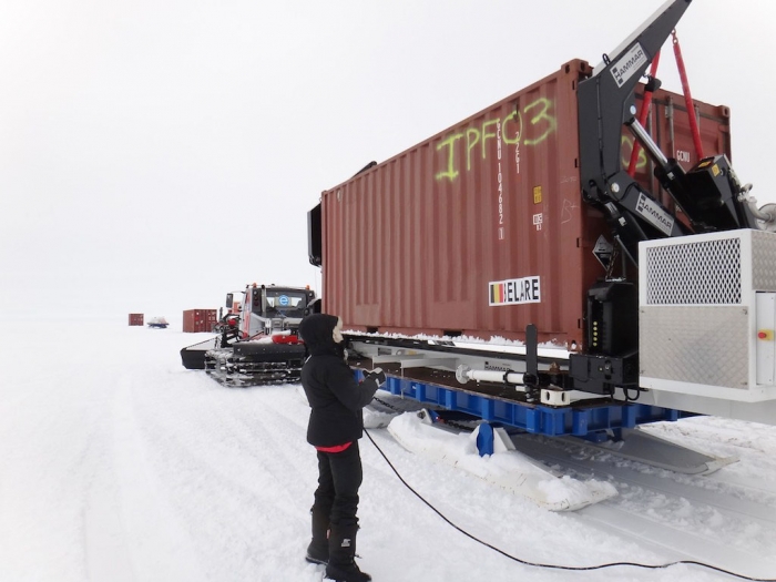 Loading container on sledge with the Hammar side loader before taking it onto the ice shelf. - International Polar Foundation
