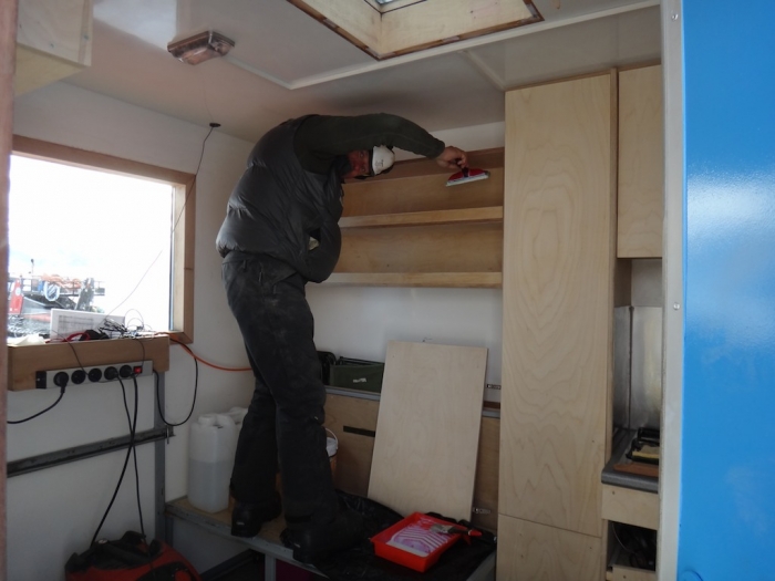 Pierre works on the furniture of the kitchen container that will head for the coast in a few days - International Polar Foundation